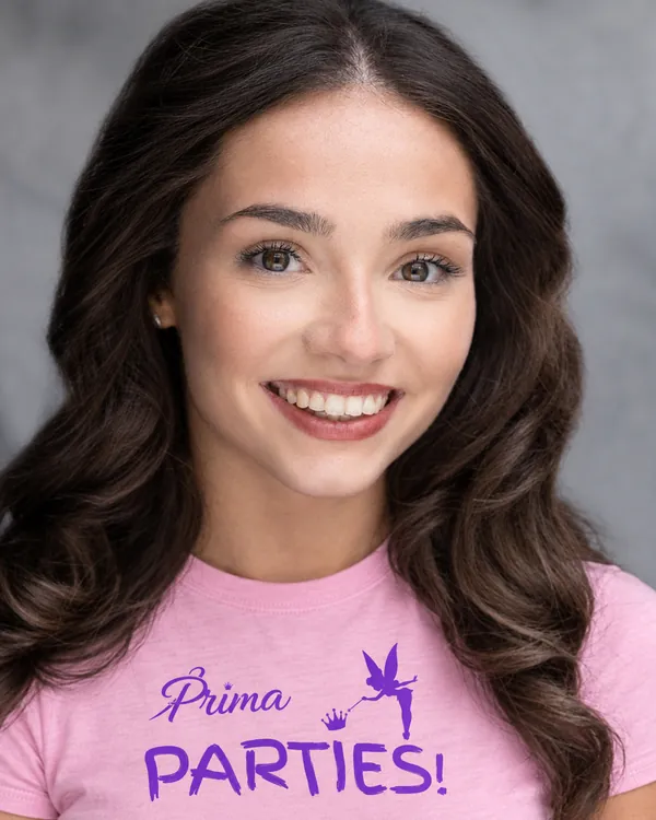 Darcy, Prima Parties performer, with long dark wavy hair and a big smile
