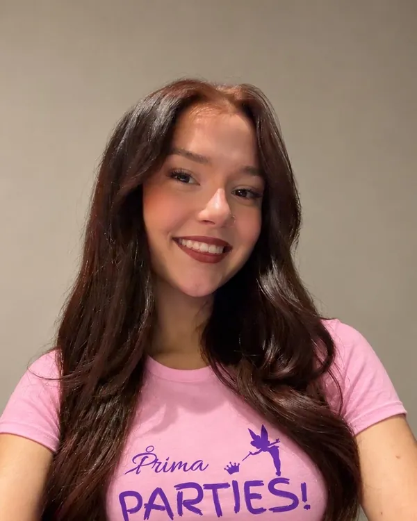 Evie, Prima Parties performer, with long dark hair, smiling