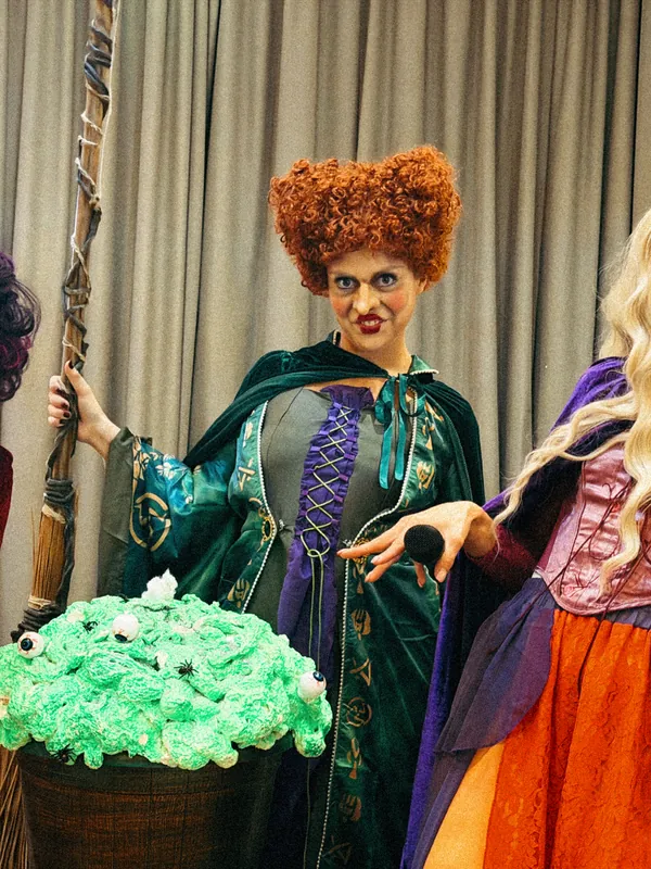 Three witch sister performers with a cauldron