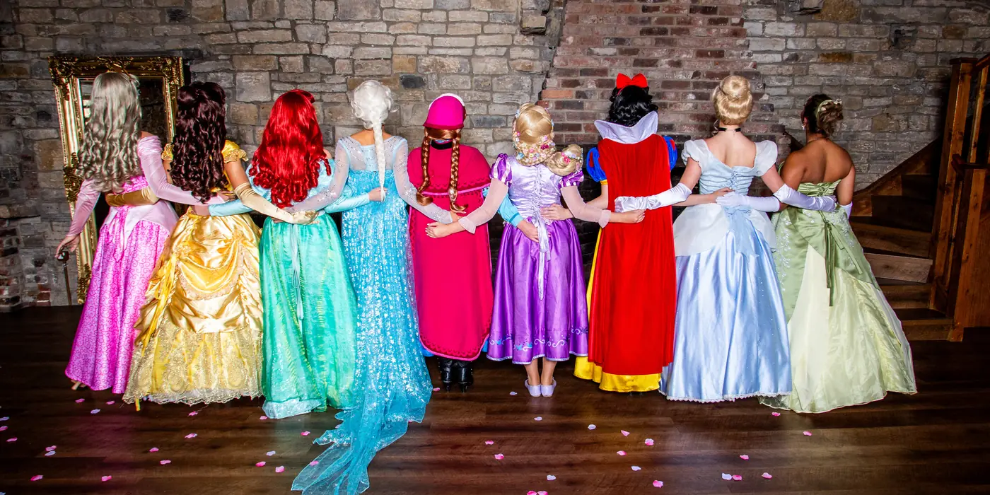 A line of Prima Parties princess performers walking arm in arm